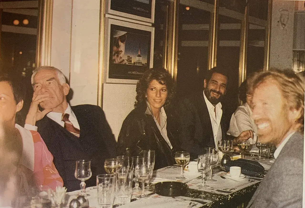 A lively gathering at Le Gastronome restaurant featuring Placido Domingo, Chuck Norris, Sylviane Katz, and Lee Marvin.