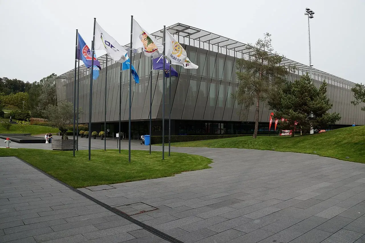 A panoramic view of the FIFA headquarters in Zurich, featuring the organization's flags and architecture.