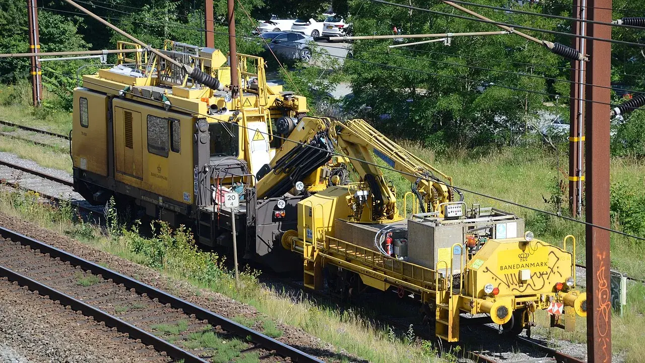 A service vehicle parked on a railway track at a train site in Kolding.
