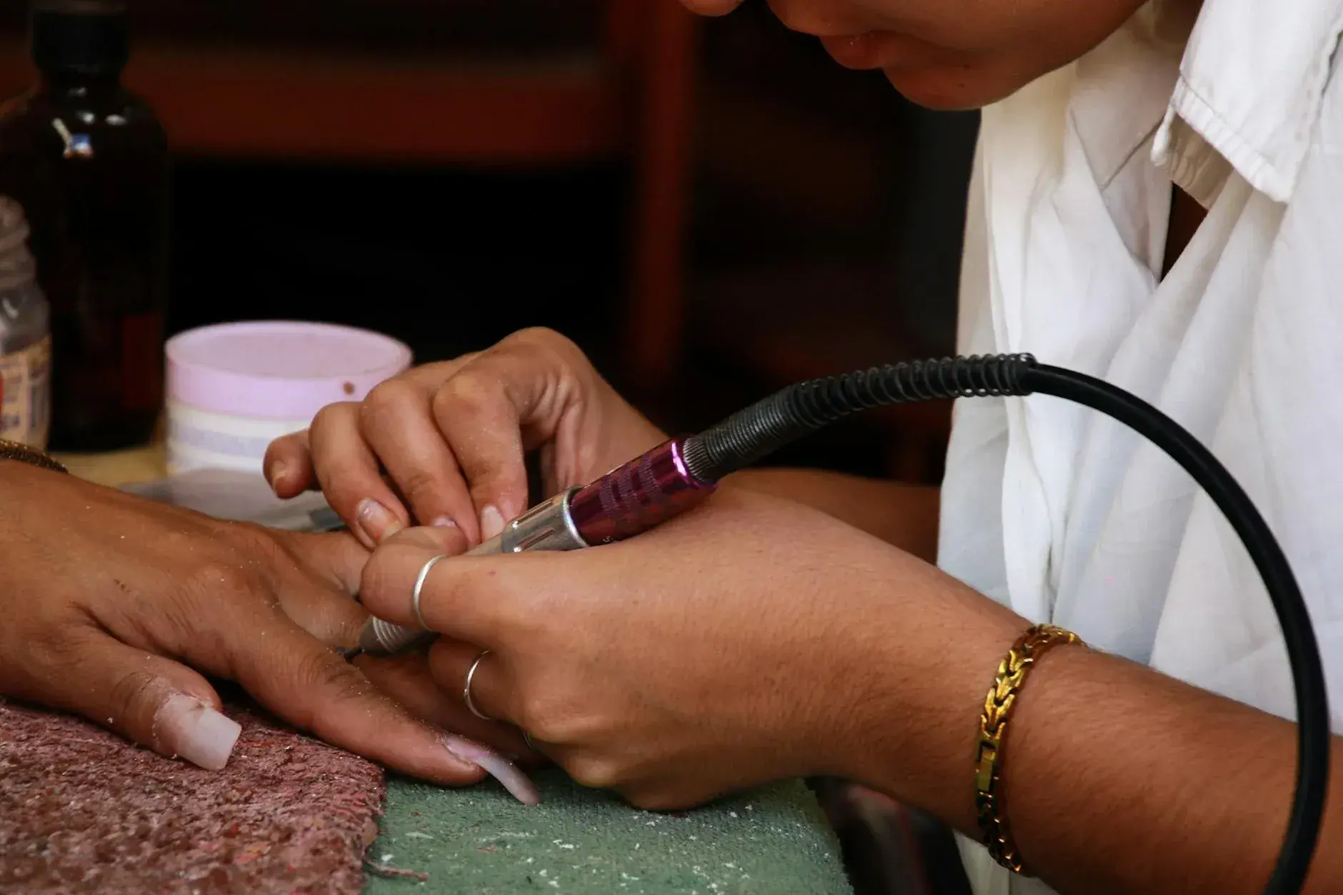 Close-up of a meticulous manicure service being performed in a high-end salon environment.