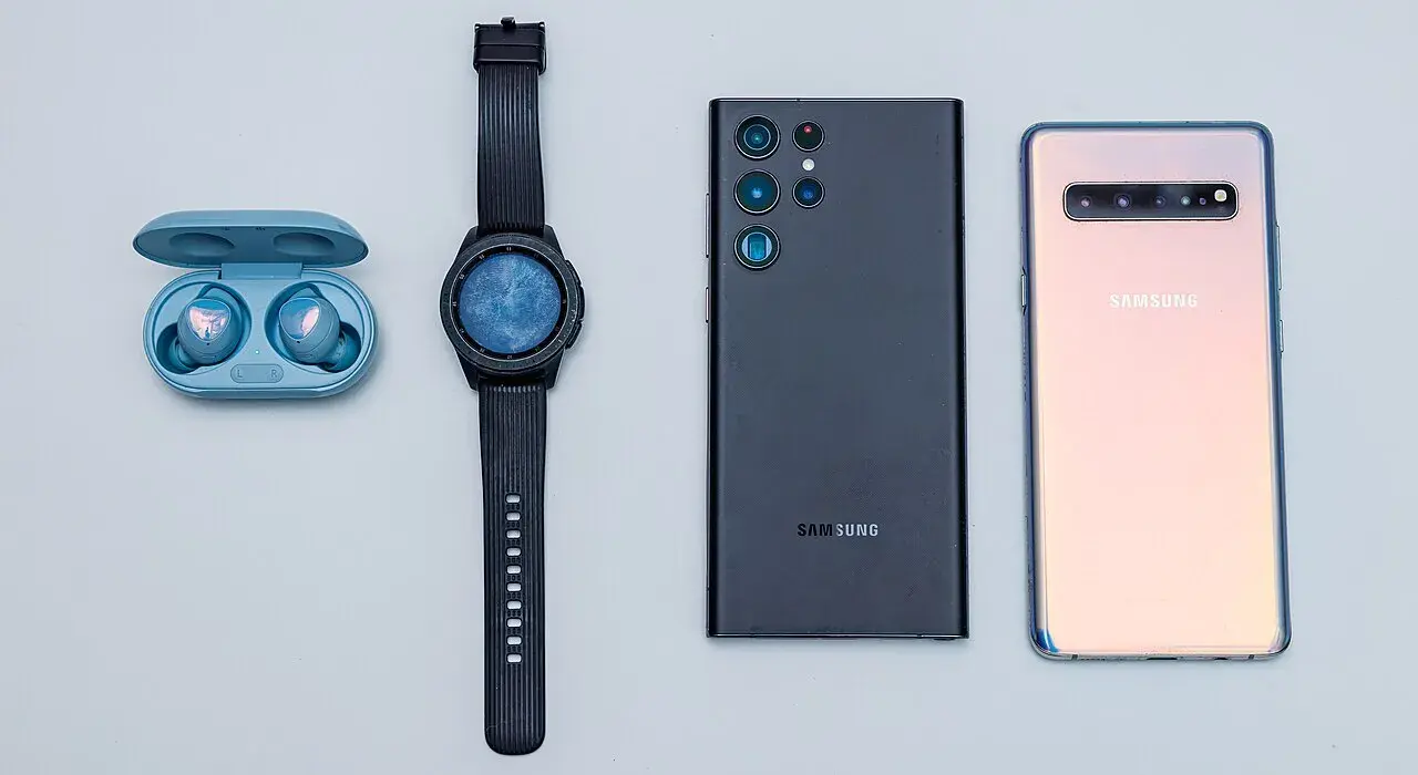 A collection of Samsung's flagship devices including earbuds, smartwatch, and smartphones.