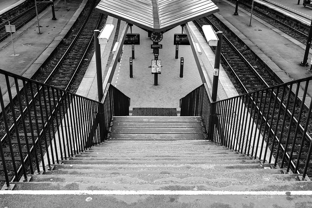 Sort/hvid fotografi af Københavns Hovedbanegård med fokus på den historiske arkitektur. Billedet fremhæver bygningens markante linjer og facadeudtryk.