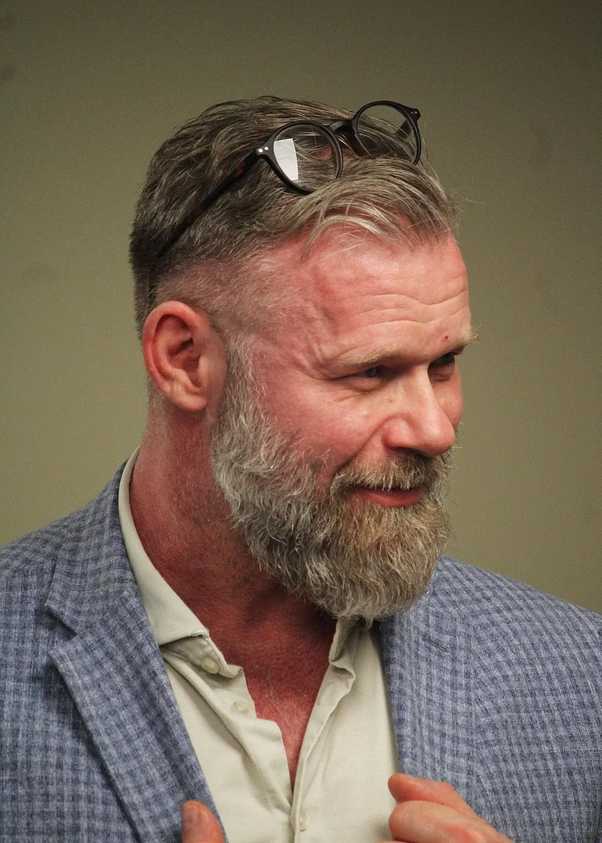 Close-up of Joachim B. Olsen speaking at a debate event.