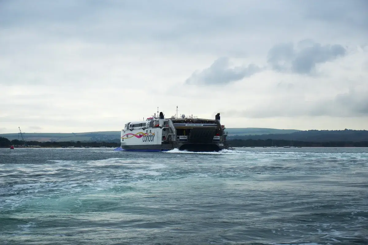 Large ferry sailing in Poole Harbour under cloudy sky