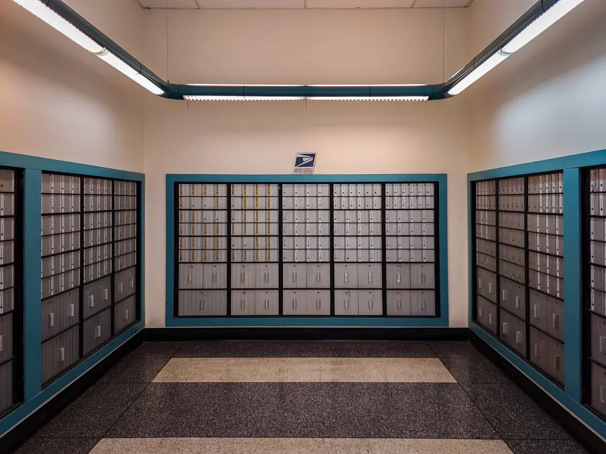 Rows of locked mailboxes inside a post office.
