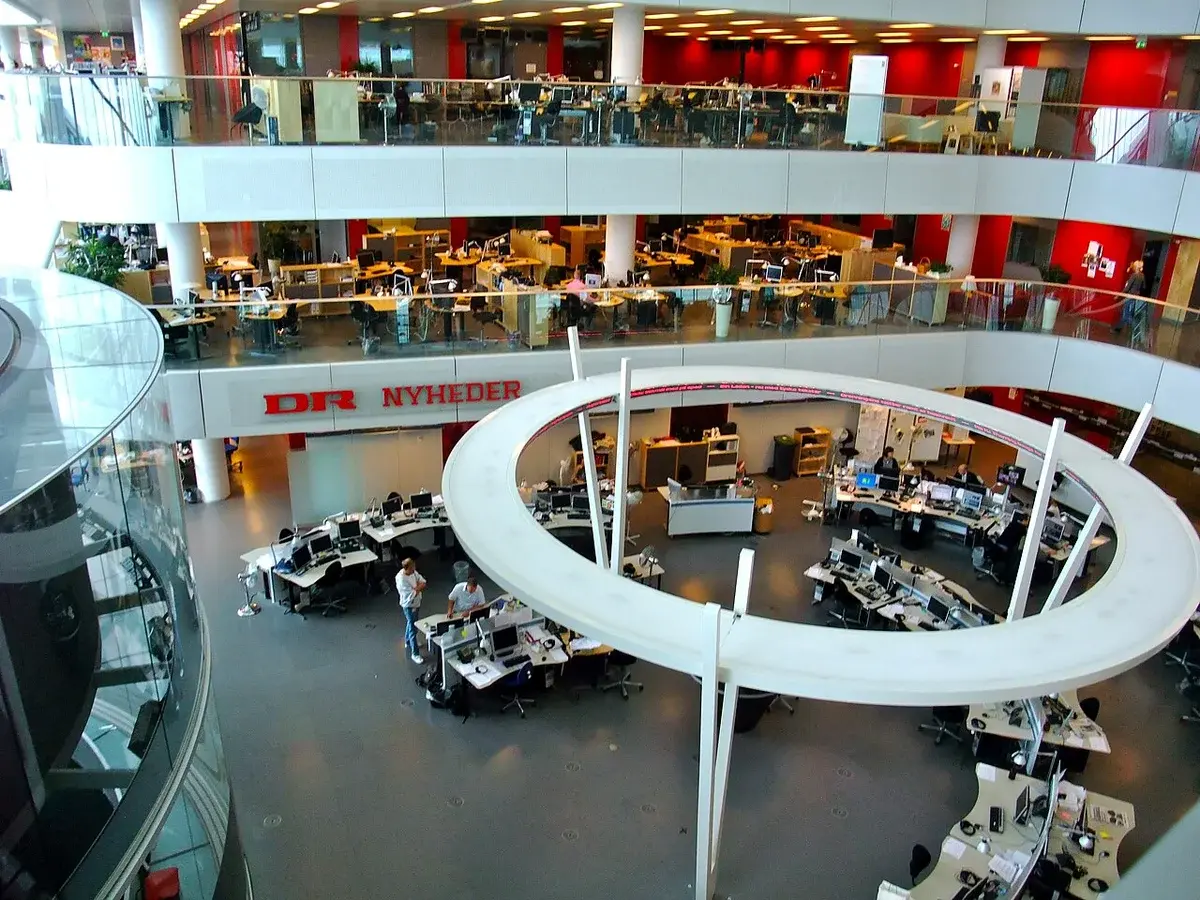 Interior view of DR news studio with journalists at desks