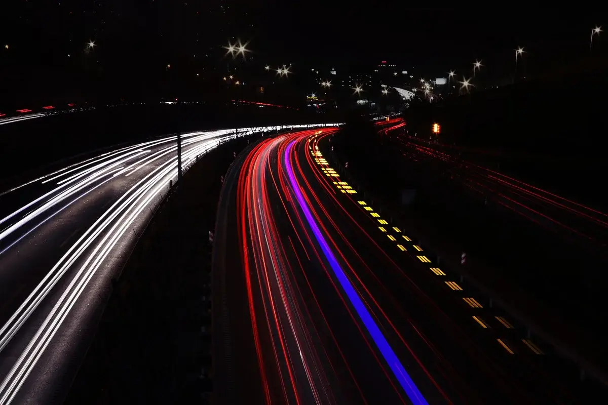 Long-exposure light trails on a highway at night