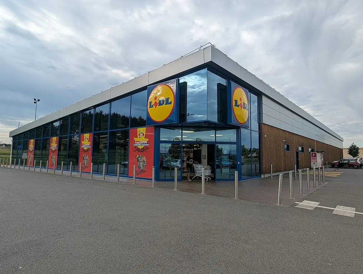 Exterior of a Lidl supermarket building with large windows and Lidl signs