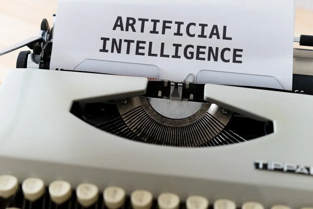 Skrivemaskine med teksten ARTIFICIAL INTELLIGENCE på papir