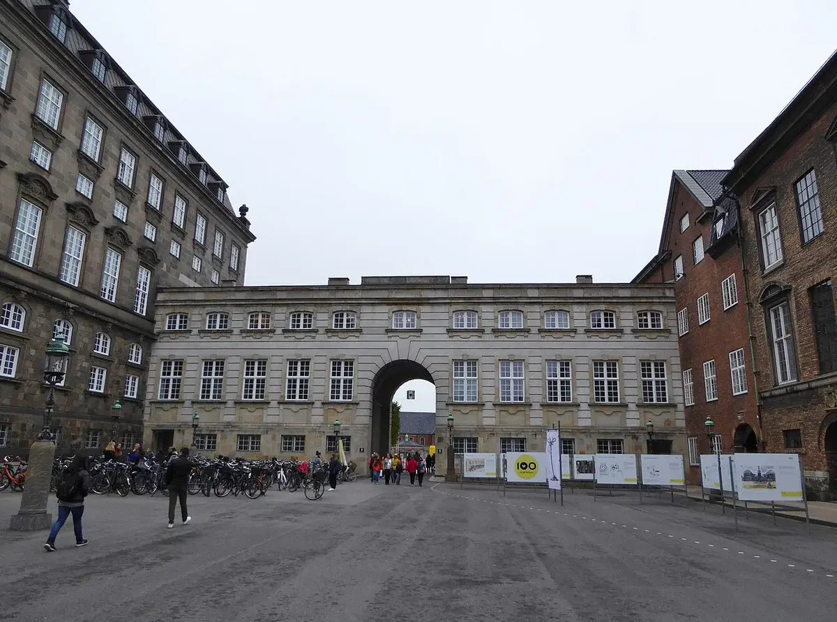Courtyard of Rigsdagsgården with historic buildings and people walking in Copenhagen