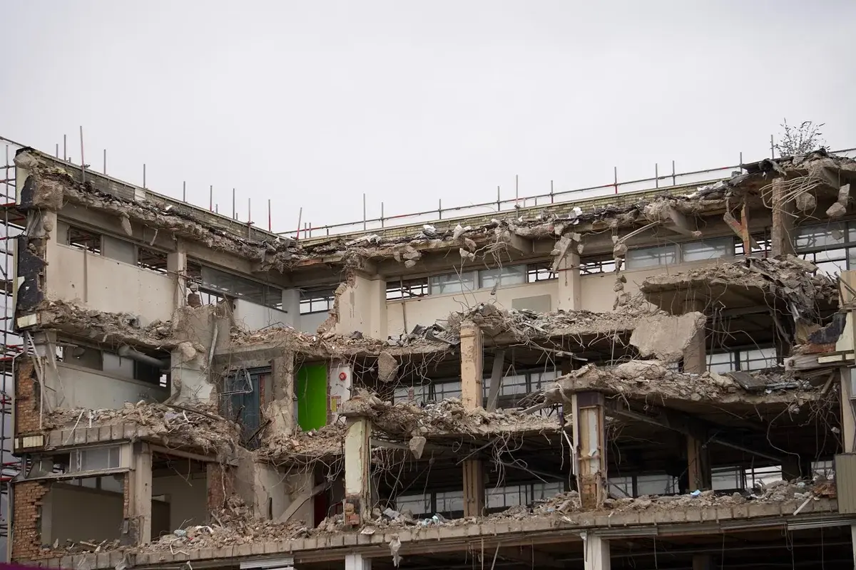 Partially demolished building with exposed concrete and debris