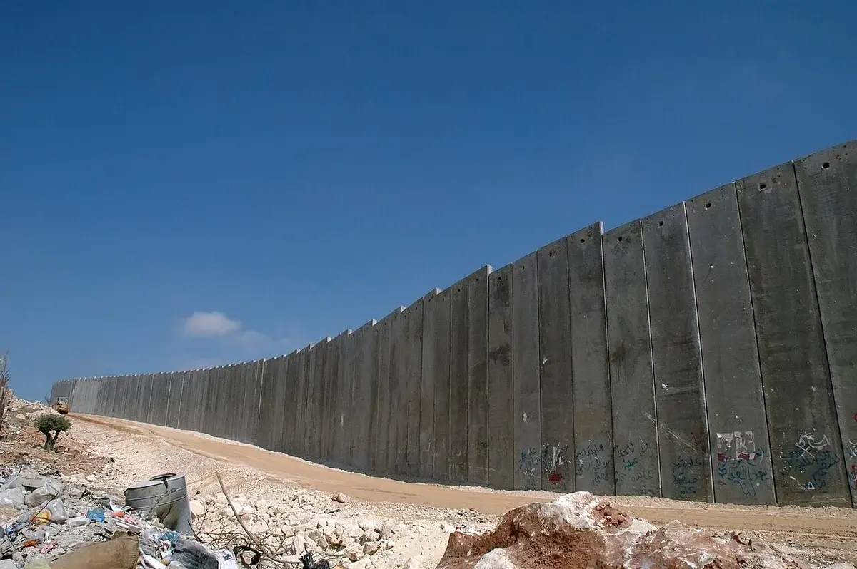 Concrete security barrier wall under clear blue sky