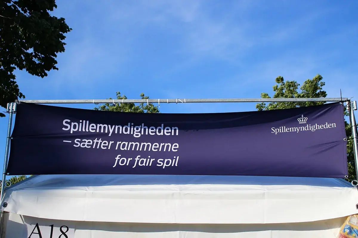 A Spillemyndigheden banner on a tent at an outdoor event.
