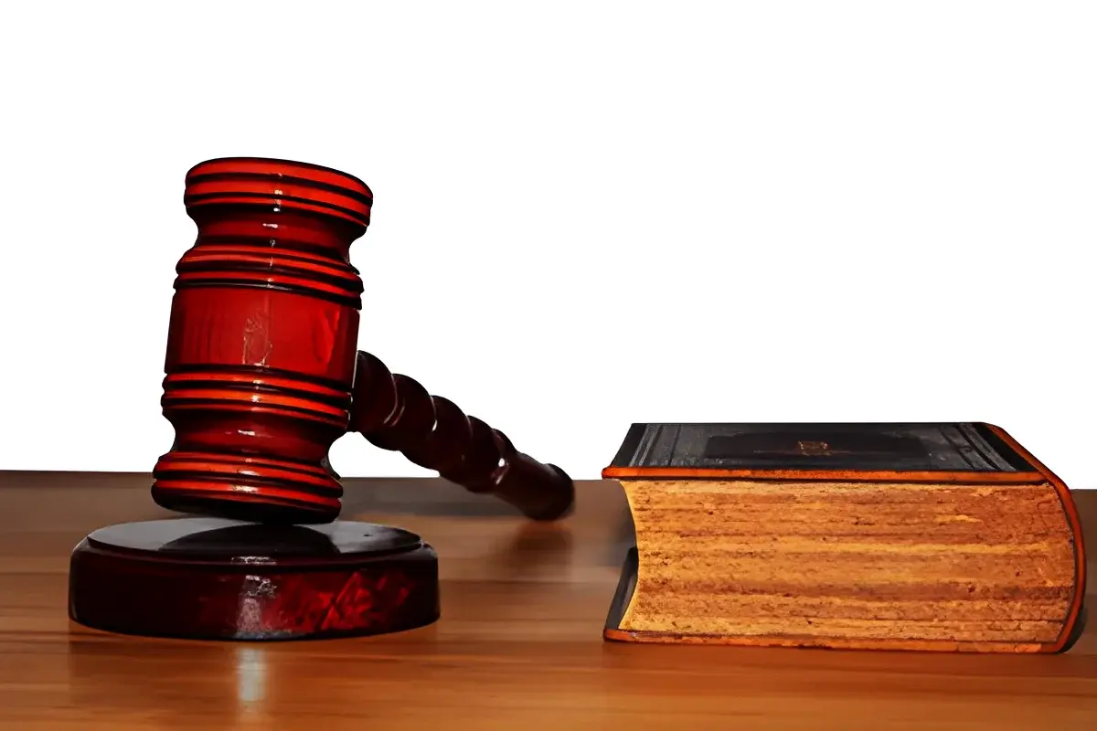 wooden gavel and legal book on table