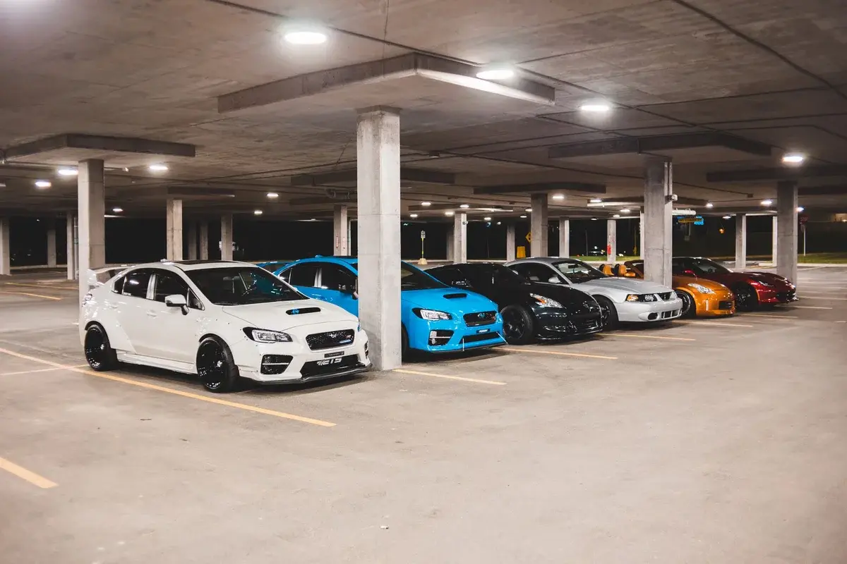 row of sports cars in indoor parking garage