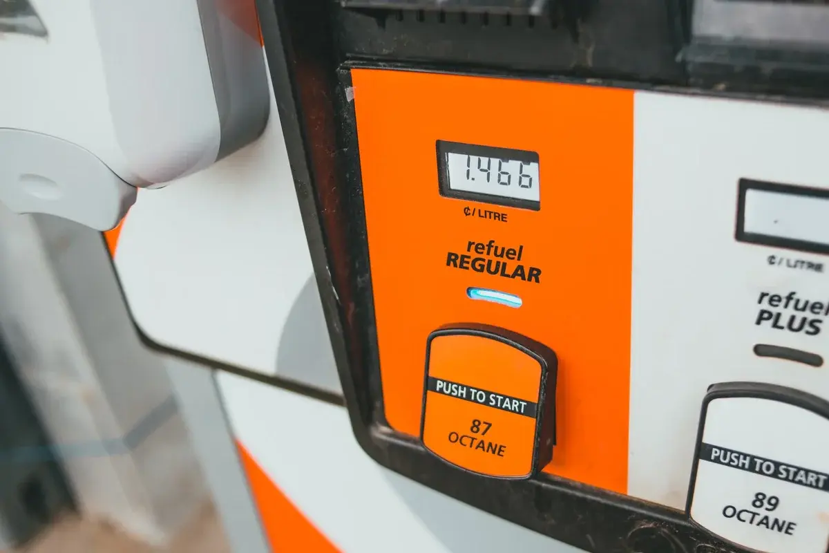 Close-up of a gas pump display showing price per litre and 87 octane regular fuel.