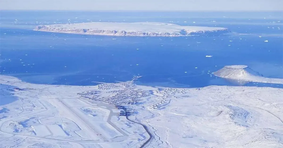 Aerial view of a snowy air base on the coast of Greenland.
