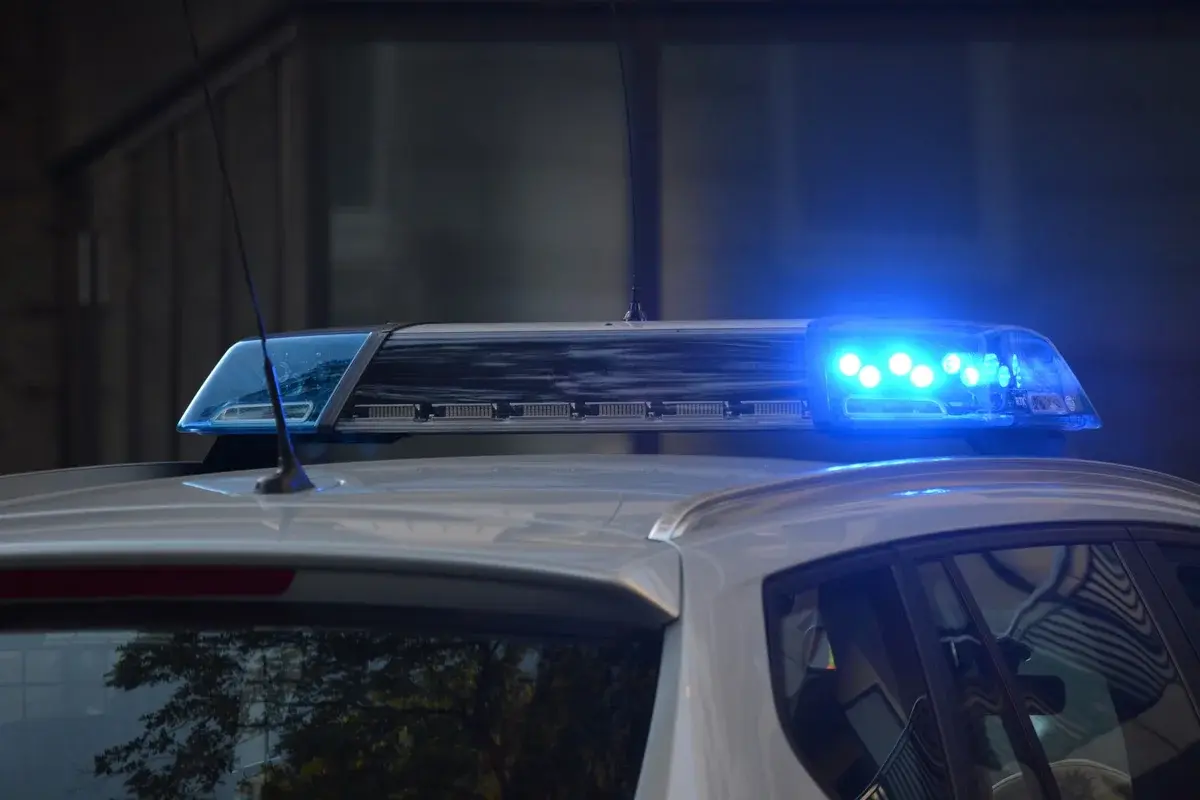 Close-up of a police car with blue flashing lights