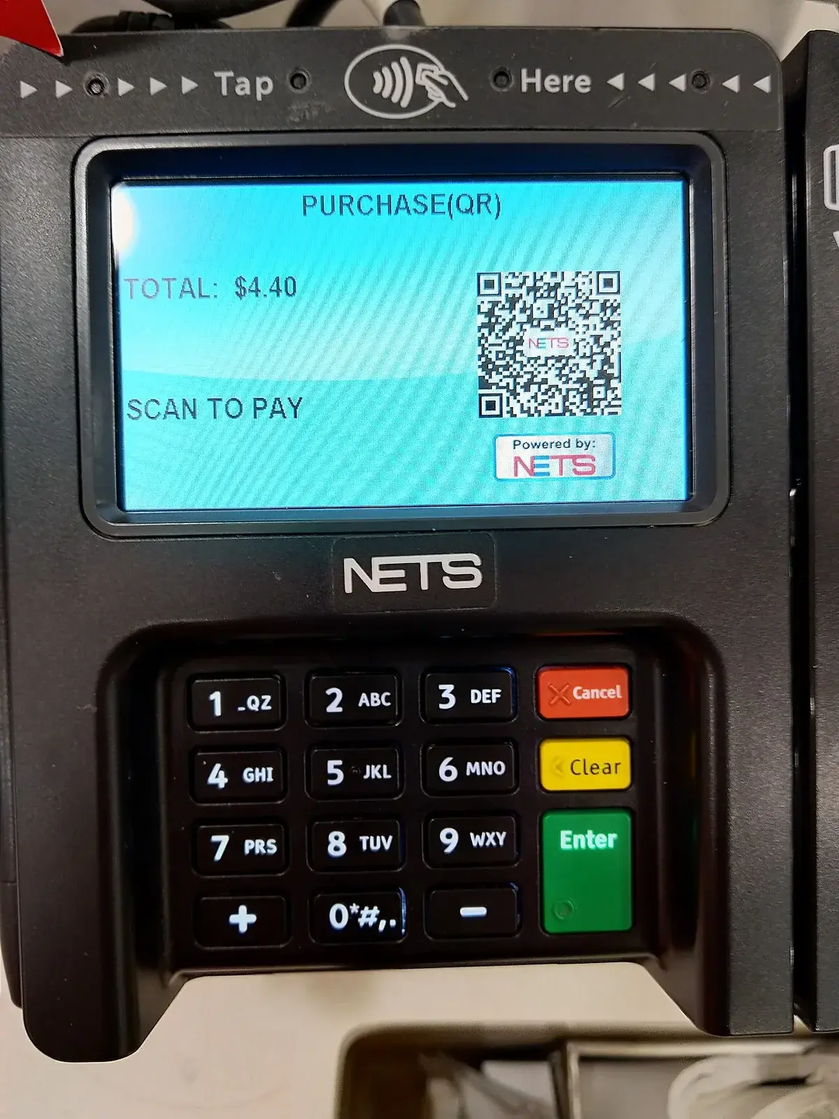 Payment terminal screen with QR code and keypad