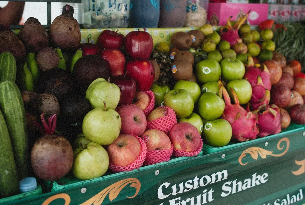 Fresh fruit selection at an outdoor market stall for custom fruit shakes