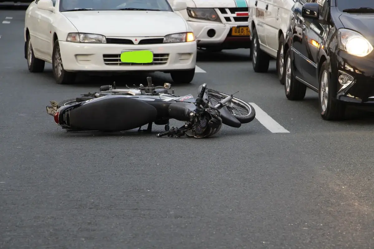 Motorcycle lying on city road after accident