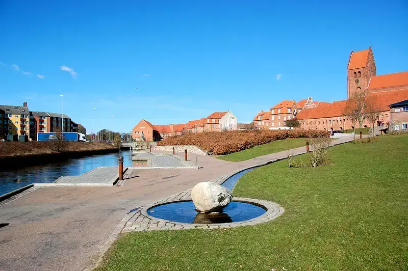 Næstved cityscape with red roofs, canal, and small water feature