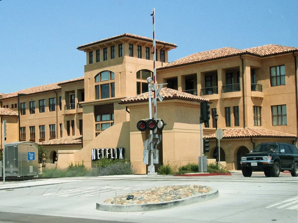 Netflix headquarters building at a street intersection in Los Gatos, California.