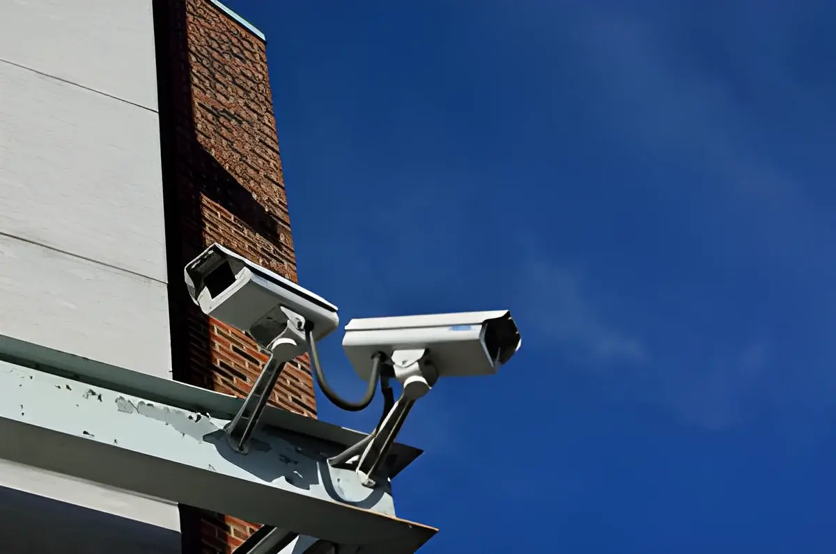Two security surveillance cameras mounted on building