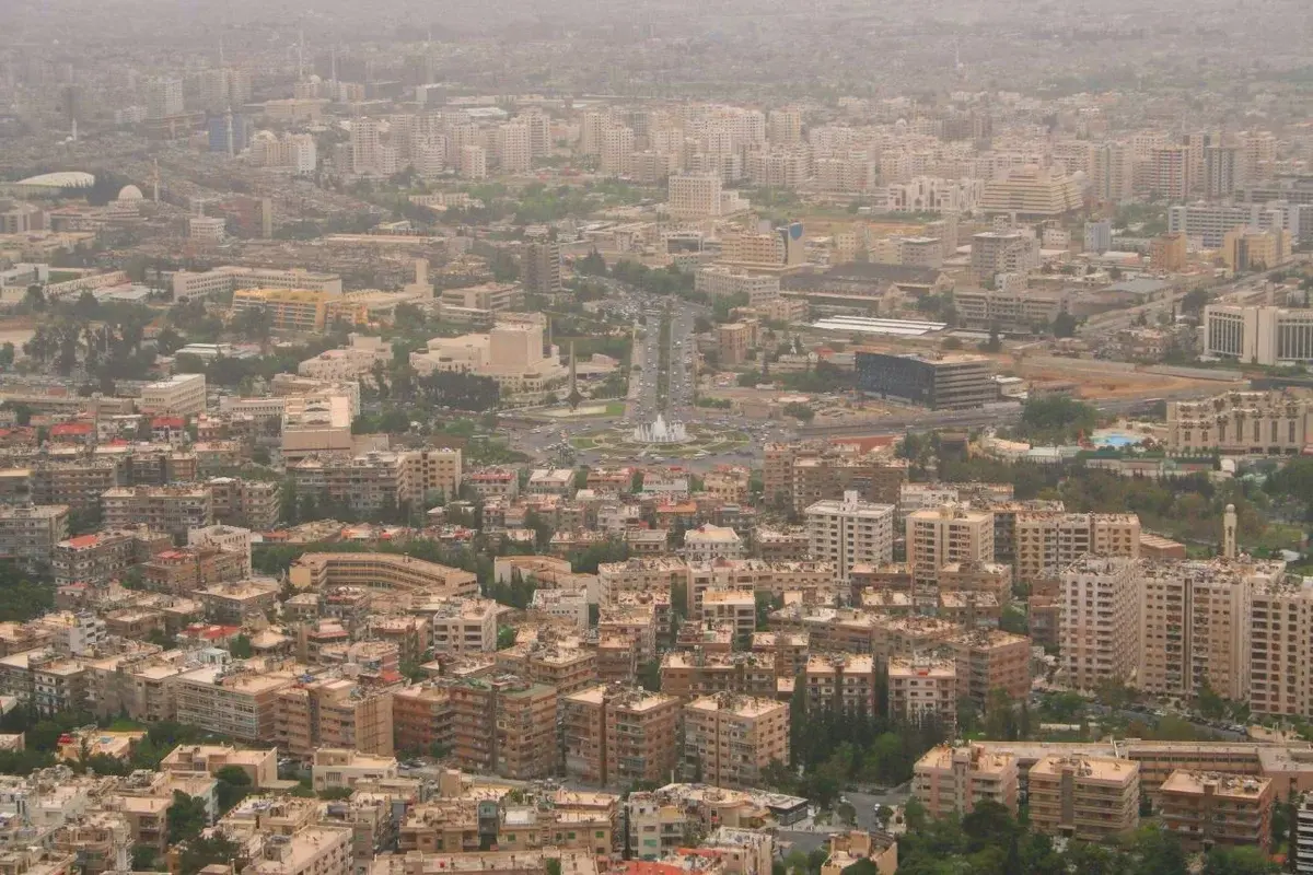 Panoramic view of Damascus skyline with dense city buildings.