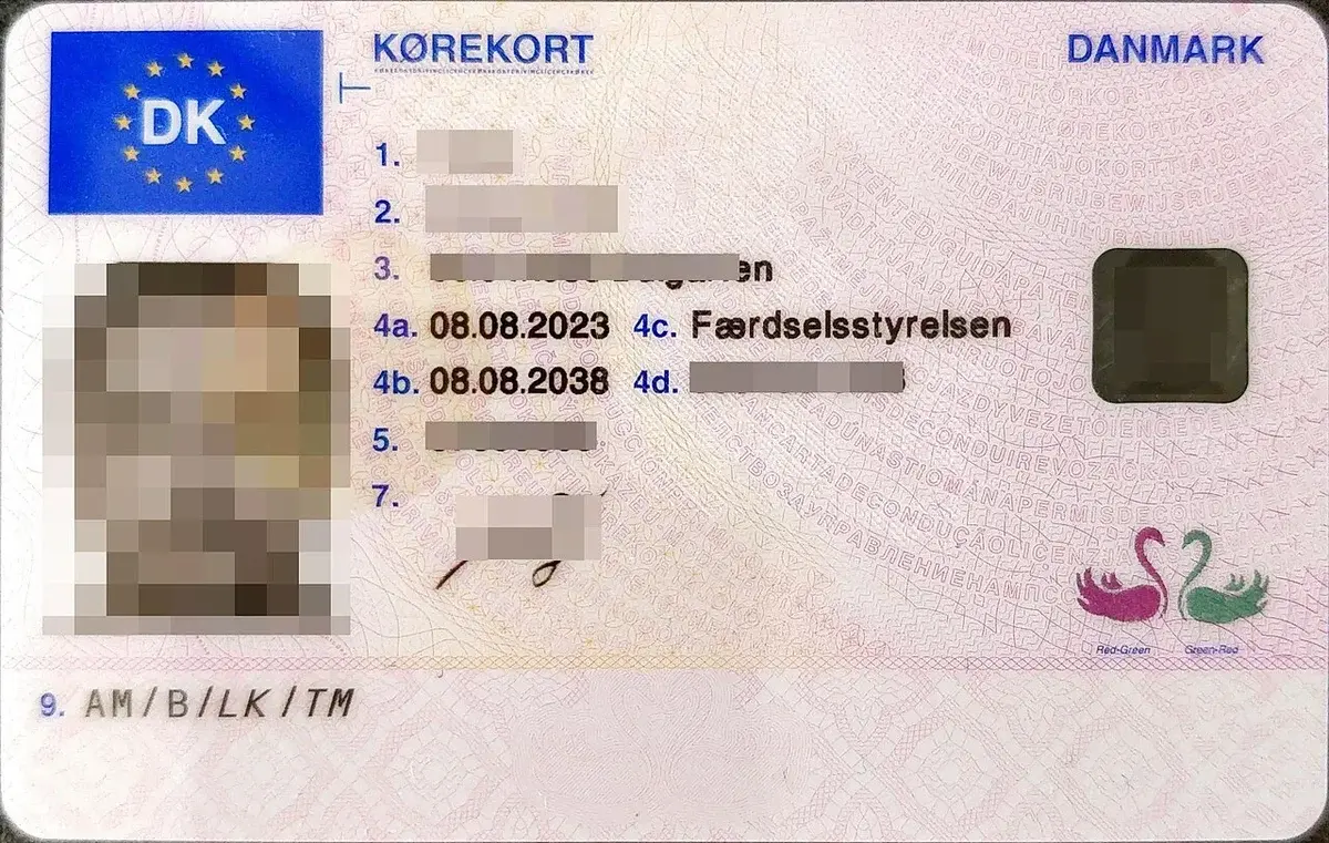 Front side of a Danish driver's license with personal details and photo blurred