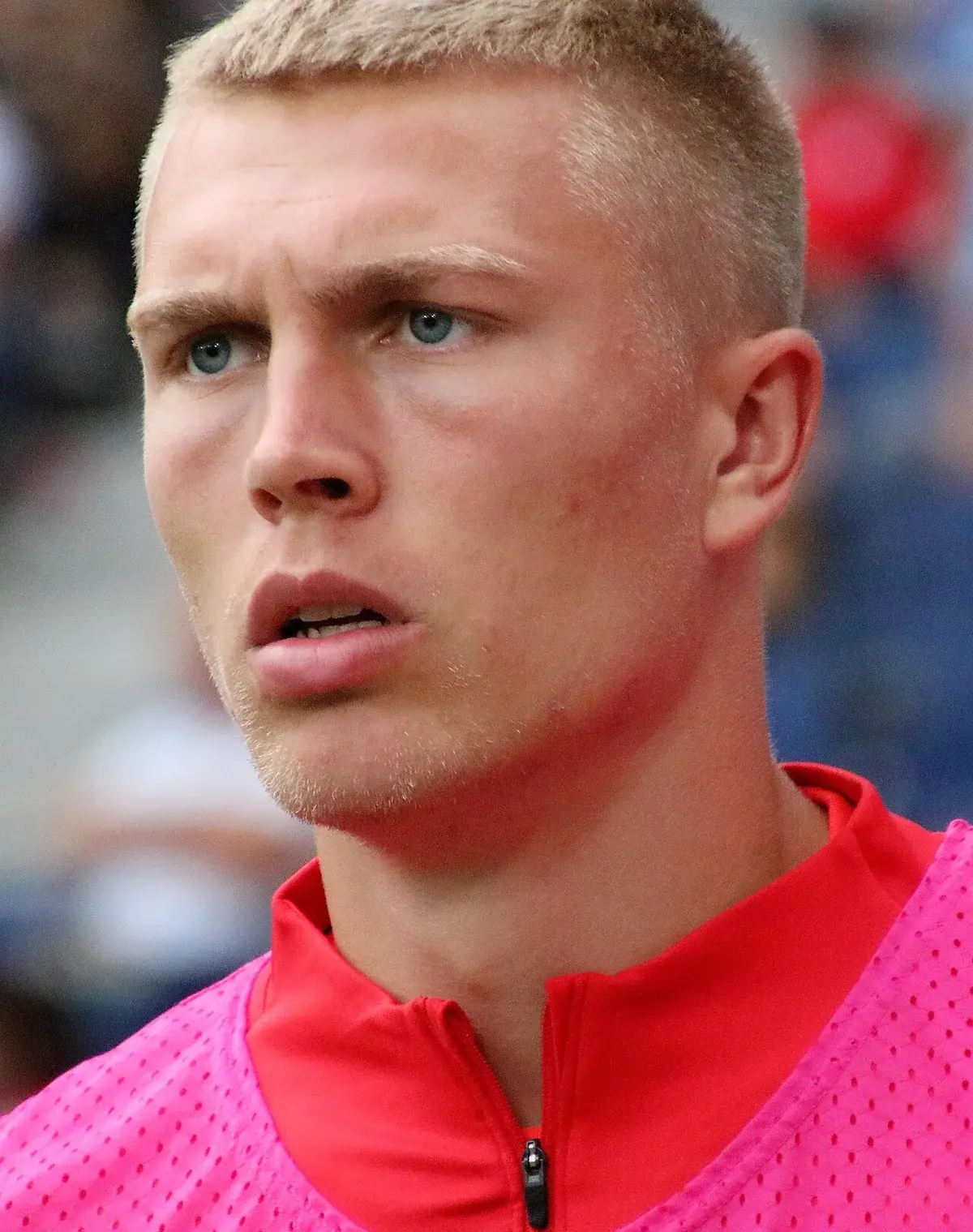 Close-up of footballer Rasmus Nissen in a red and pink warm-up top.