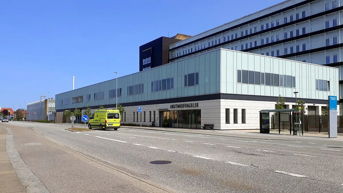 Hospital emergency department building with an ambulance outside.