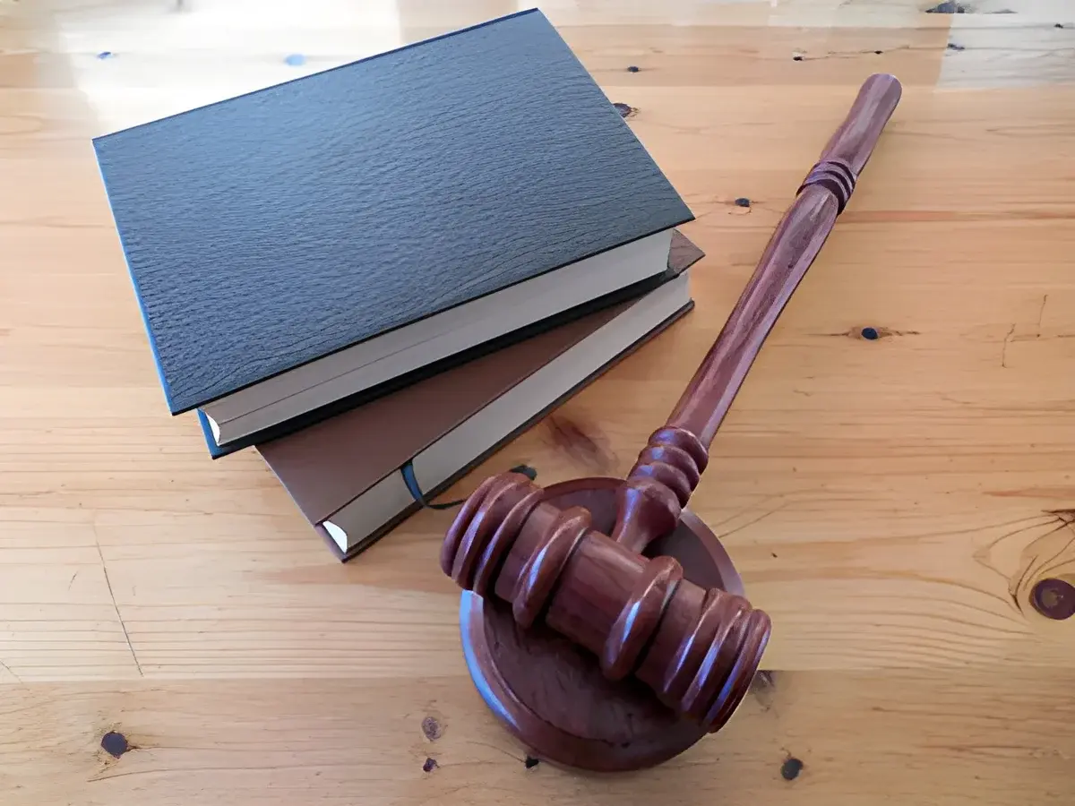 Judge's gavel on sound block with law books