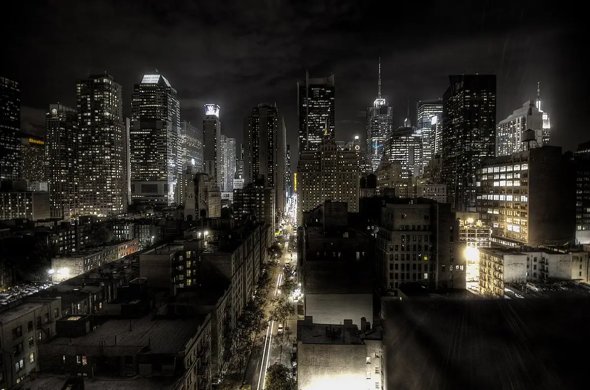 Night view of the New York City skyline along West 45th Street.