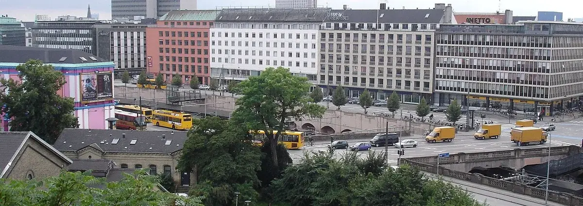 Busy street traffic at Vesterport in Copenhagen with buses, cars, and trucks.