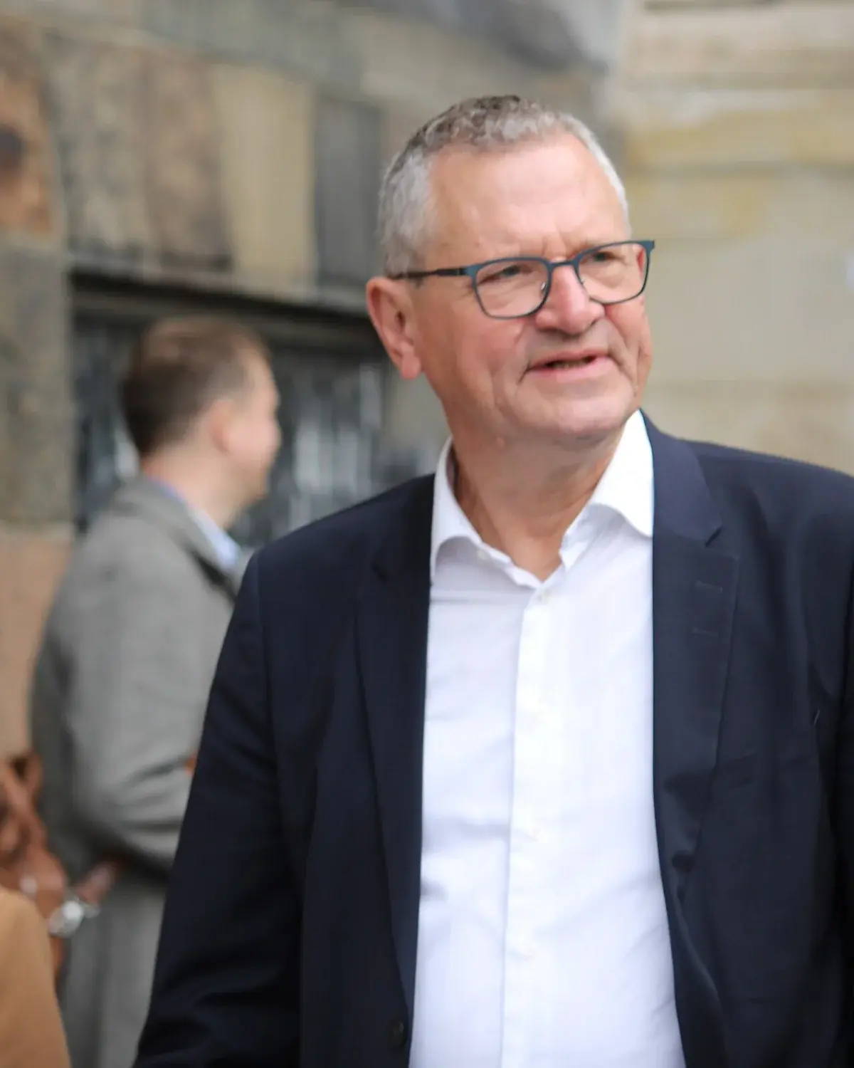 Henrik Frandsen standing outside near Christiansborg in a suit.