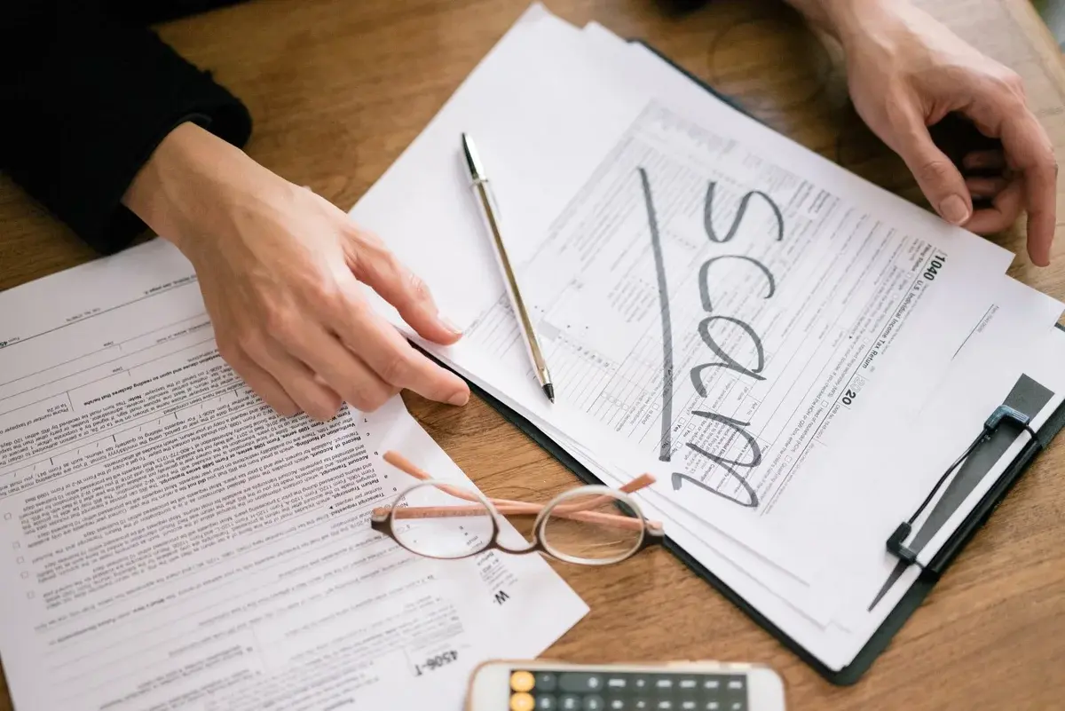 Tax forms on desk marked with the word scam
