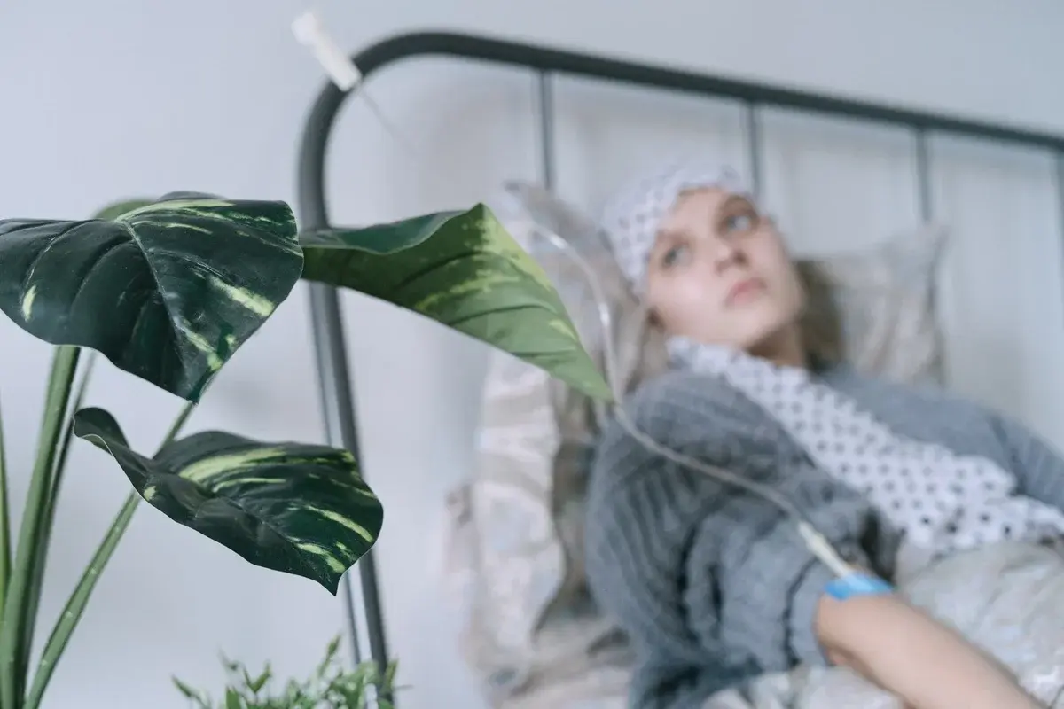 patient lying in hospital bed with IV drip