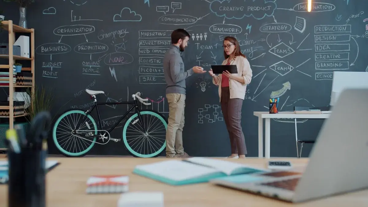 Two people discussing ideas in a modern office.
