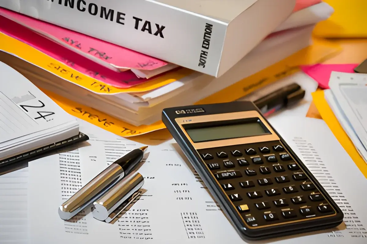Calculator and income tax documents on table