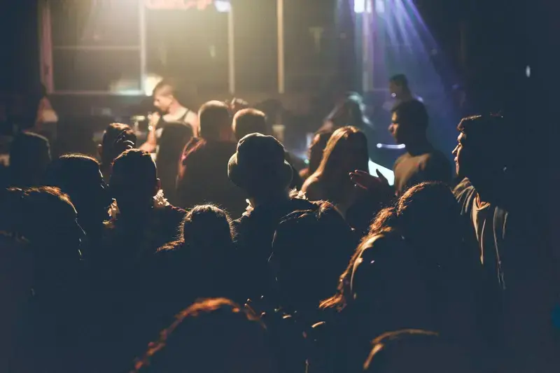 people socializing in a dark venue