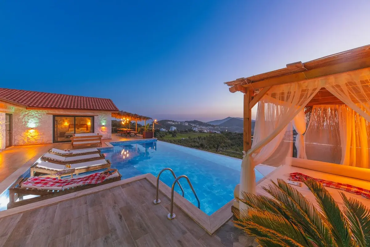 Luxury villa with infinity pool and cabana overlooking Kas at sunset