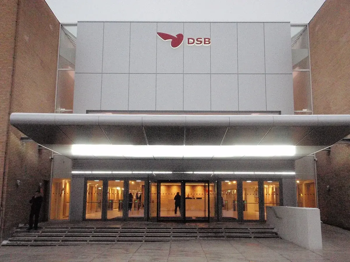 Main entrance of DSB headquarters building with illuminated logo