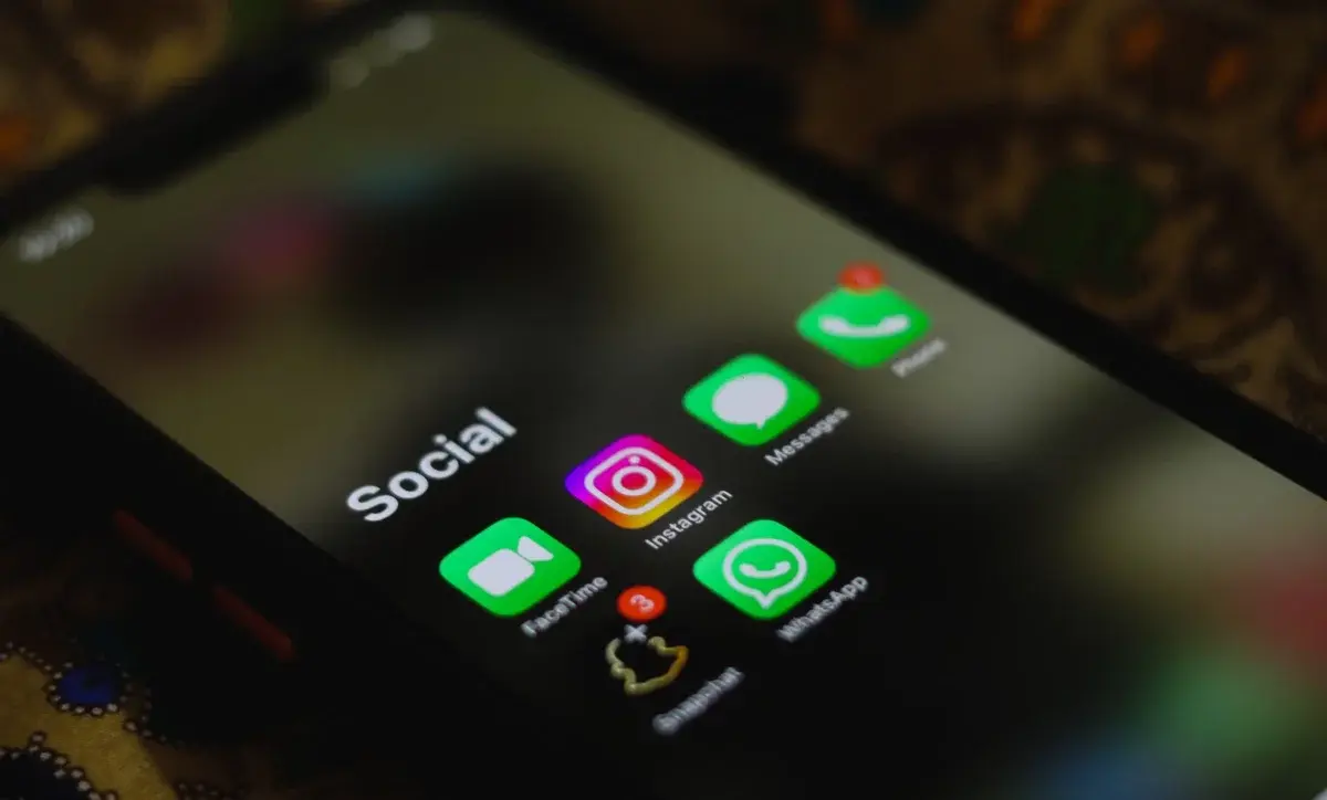 Close-up of a smartphone screen with social media and messaging app icons.