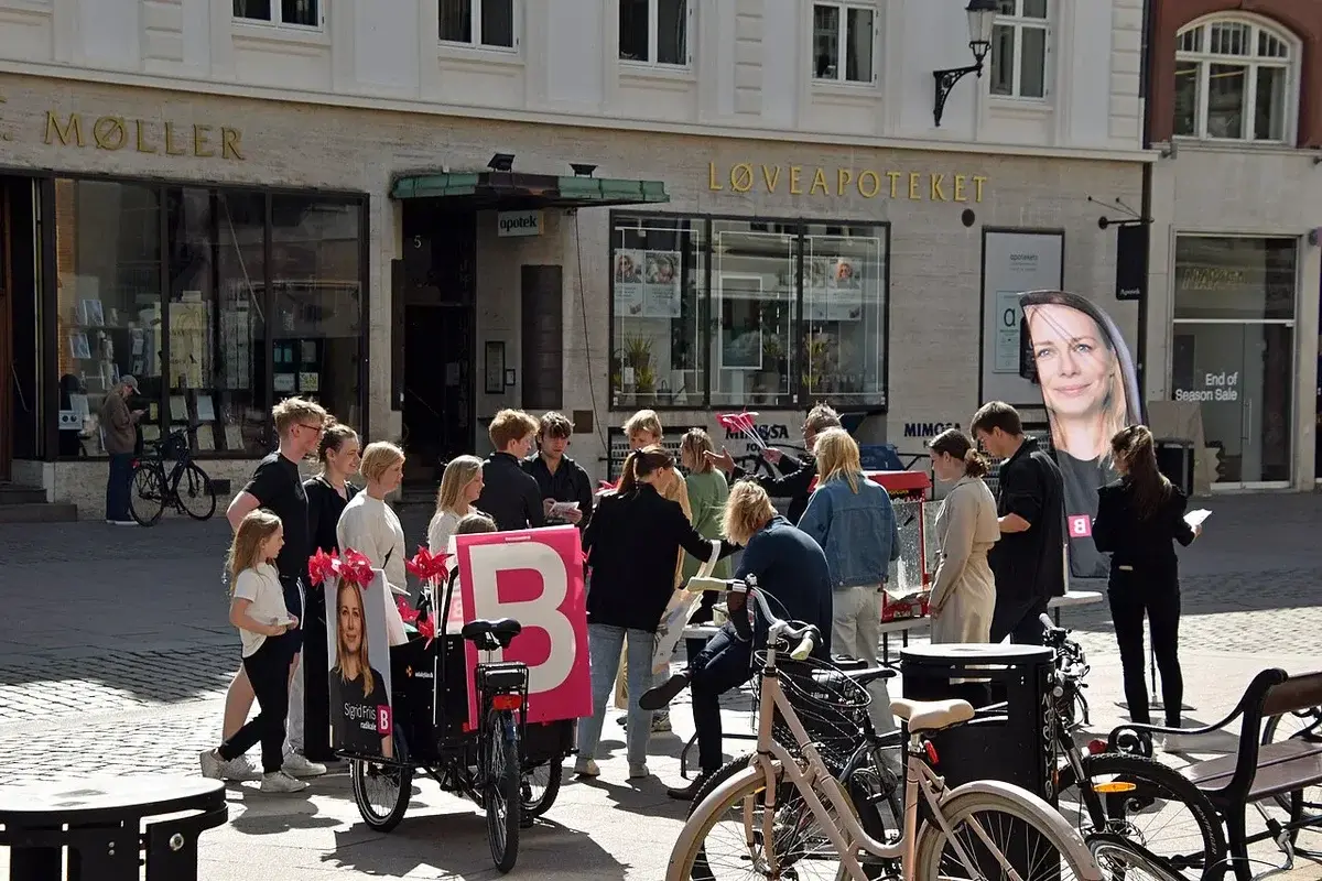 Group of people campaigning with banners and bicycles in a public square