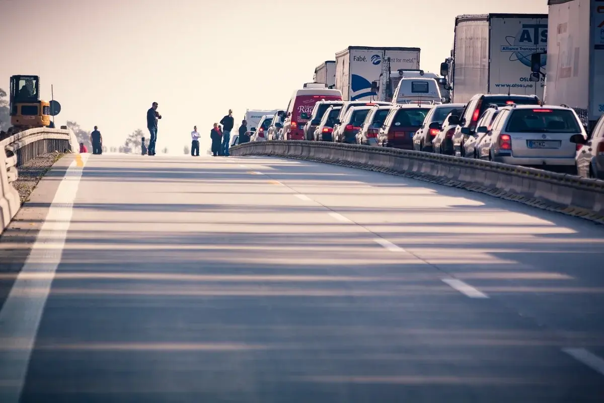 Traffic jam on a highway with vehicles and people