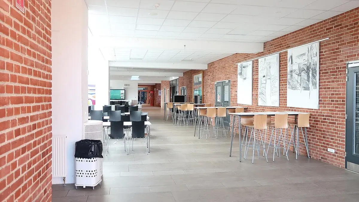 hallway with tables and chairs inside a school building
