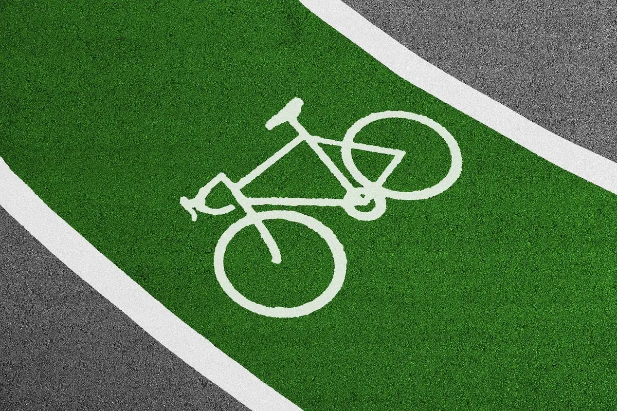 Green bicycle lane with white bike symbol