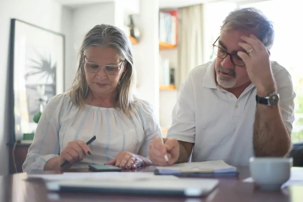 Middle-aged couple calculating household bills