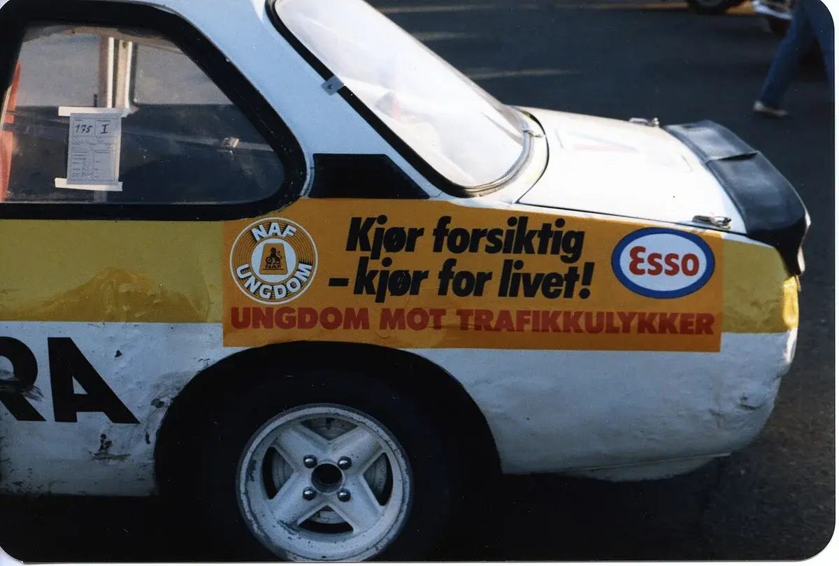 Side of a car with NAF and Esso road safety campaign stickers.